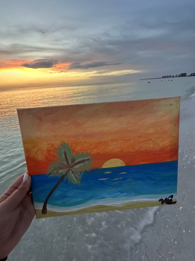 Hand holding a painted seashell with a sunset beach scene by the Gulf, Marco Island, Florida