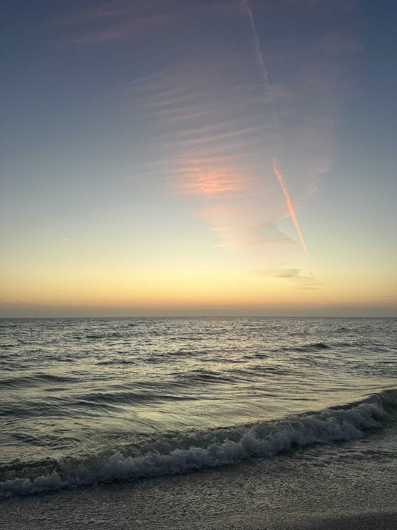 Soft sunset over rolling Gulf waves washing onto the shoreline, Marco Island, Florida